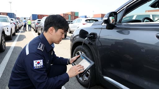 Professional vehicle inspector examining a car with diagnostic equipment